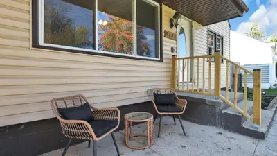 two chairs and a table sitting on a porch at Hearth Home Brick Oven Karaoke 4 Bedroom fits 8 in Columbus