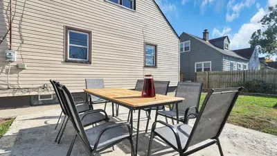 a wooden table and chairs on a patio at Hearth Home Brick Oven Karaoke 4 Bedroom fits 8 in Columbus