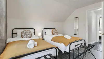two beds sitting next to each other in a room at Hearth Home Brick Oven Karaoke 4 Bedroom fits 8 in Columbus