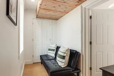a living room with a black leather couch at 2 Mi to Ark Encounter! Walkable Williamstown Condo in Williamstown