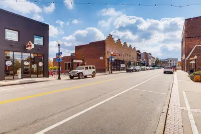 an empty street in a town with cars driving down it at 2 Mi to Ark Encounter! Walkable Williamstown Condo in Williamstown