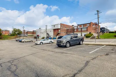 a truck parked in a parking lot with cars at 2 Mi to Ark Encounter! Walkable Williamstown Condo in Williamstown