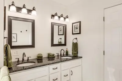 a bathroom with two sinks and two mirrors at 2 Mi to Ark Encounter! Walkable Williamstown Condo in Williamstown