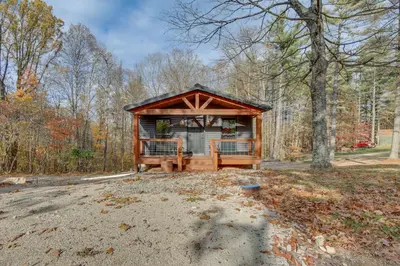 a small cabin in the middle of a forest at Chène Cottage Near Burr Oak Lake and Trailheads! in Glouster