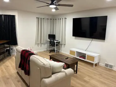 a living room with a couch and a flat screen tv at Oilgate at Parkgate in Akron
