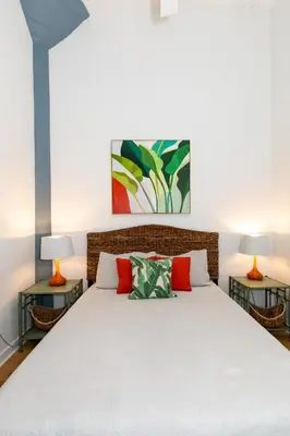 a bedroom with a large bed with two lamps at Downtown Condo 5 Minutes to Cedar Point in Sandusky