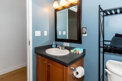 a bathroom with a sink and a mirror at Downtown Condo 5 Minutes to Cedar Point in Sandusky