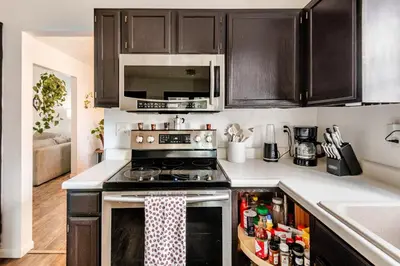 a kitchen with a stove and a microwave at Cozy boho Retreat in Grove City