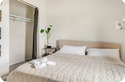 a bedroom with a bed with two white towels on it at Cozy boho Retreat in Grove City