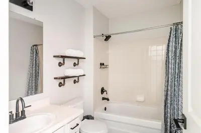 a white bathroom with a tub and a toilet and a sink at Cozy boho Retreat in Grove City