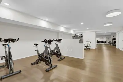 a gym with treadmills and exercise bikes in a room at Luxury lofts, Downtown, Playhouse Sq, Near Stadium and Arena, Fire Pit, Rooftop deck, BBQ, Parking -fcfs, Close to EVERYTHIHNG! in Cleveland