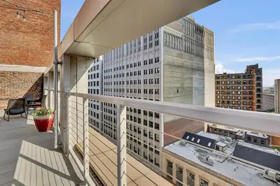 a balcony with a view of a building at Luxury lofts, Downtown, Playhouse Sq, Near Stadium and Arena, Fire Pit, Rooftop deck, BBQ, Parking -fcfs, Close to EVERYTHIHNG! in Cleveland