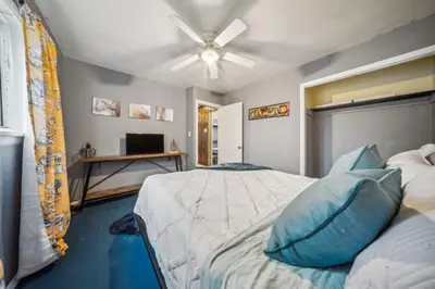 a bedroom with two beds and a ceiling fan at Blue Bayou Cozy in South Cleveland in Cleveland