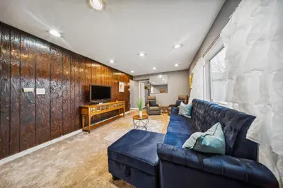 a living room with a couch and a television at Blue Bayou Cozy in South Cleveland in Cleveland