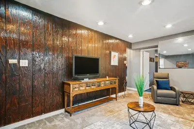 a living room with a large wooden wall at Blue Bayou Cozy in South Cleveland in Cleveland