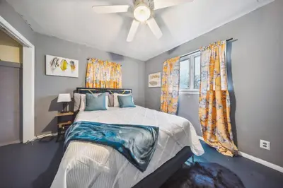 a bedroom with a bed and a ceiling fan at Blue Bayou Cozy in South Cleveland in Cleveland