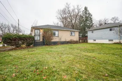 a house with a yard in front of a house at Blue Bayou Cozy in South Cleveland in Cleveland