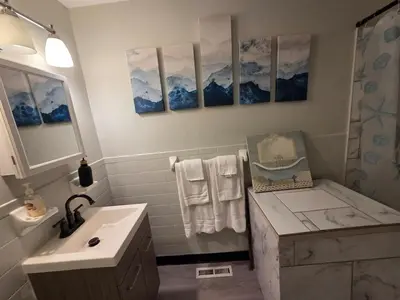 a bathroom with a sink and a shower at Great little house in Woodmere Beachwood Orange in Woodmere