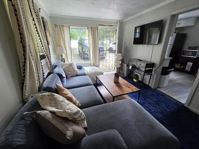 a living room with two couches and a table at Great little house in Woodmere Beachwood Orange in Woodmere