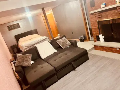 a living room with a couch and a bed at Del La Rose in Clarksburg