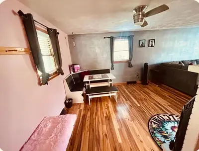 a living room with a couch and a table at Del La Rose in Clarksburg