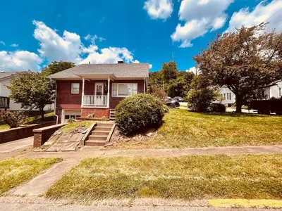 a red house with stairs in a yard at Del La Rose in Clarksburg