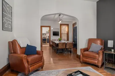 a living room with two chairs and a table at Short North Luxury 4BR Free Parking & Fire Pit in Columbus