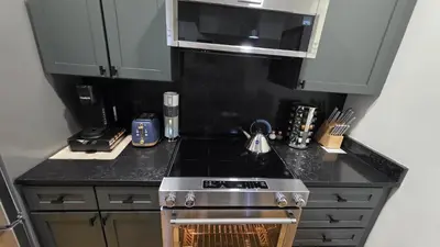 a kitchen with a stove and a microwave at Quiet cheerful condo in the heart of OTR! in Cincinnati
