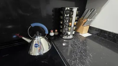 a tea kettle sitting on top of a kitchen counter at Quiet cheerful condo in the heart of OTR! in Cincinnati