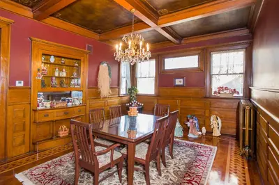 a dining room with a wooden table and chairs at Market Street Inn in Wooster