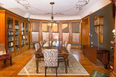 a dining room with a wooden table and chairs at Market Street Inn in Wooster