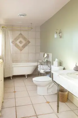 a bathroom with a toilet and a tub and a sink at Market Street Inn in Wooster