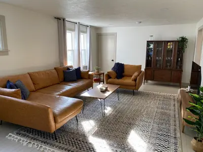 a living room with a couch and chairs and a table at Totally renovated large family getaway! King bed