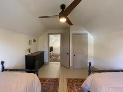a bedroom with two beds and a ceiling fan at Totally renovated large family getaway! King bed