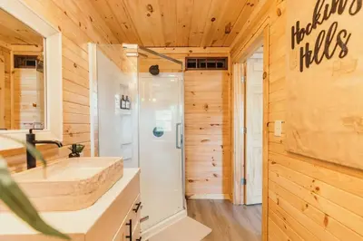 a bathroom with a shower and a sink at Creekside Hocking Hills Cabin-Game Shed Hot Tub in South Bloomingville