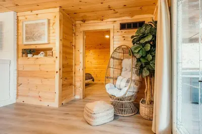 a sauna with a wicker chair in a wooden room at Creekside Hocking Hills Cabin-Game Shed Hot Tub in South Bloomingville