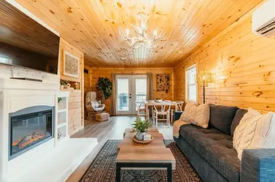 a living room with a couch and a fireplace at Creekside Hocking Hills Cabin-Game Shed Hot Tub in South Bloomingville
