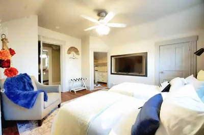 a bedroom with two beds and a flat screen tv at Nell's Place in Cincinnati