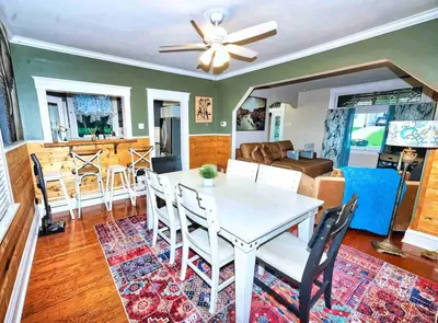 a dining room and living room with a table and chairs at Nell's Place in Cincinnati