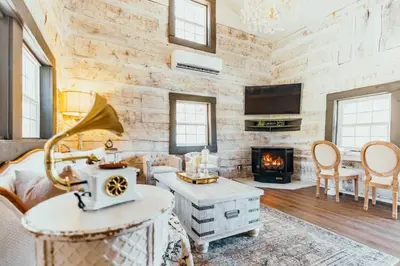 a living room with a stone wall at Victorian French Cottage - Hot Tub in Hocking Hills in South Bloomingville