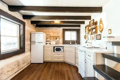 a kitchen with white appliances and a white refrigerator at Victorian French Cottage - Hot Tub in Hocking Hills in South Bloomingville