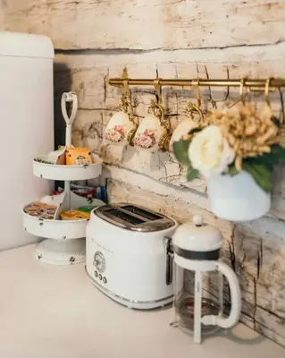 a counter with a toaster and other items on it at Victorian French Cottage - Hot Tub in Hocking Hills in South Bloomingville