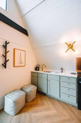 an attic kitchen with a sink and a stool at Secluded A-Frame Hocking Hills Hot Tub Fire Pit in South Bloomingville