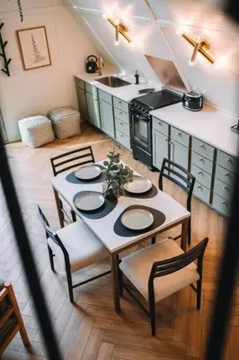 a kitchen with a table with chairs and a stove at Secluded A-Frame Hocking Hills Hot Tub Fire Pit in South Bloomingville