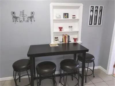 a black table with four chairs in a room at Affordable for 8 guests-King bed-2 Baths-Firepit in Brooklyn