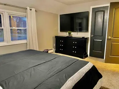 a bedroom with a bed and a dresser and a television at [4-BR/Sleeps 12] Family & Friends Home in Indiana in New Haven
