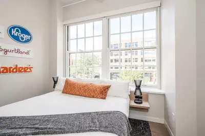 a bedroom with a bed and a window at The 333 Suites 203 - Stay for 6 in Cincinnati