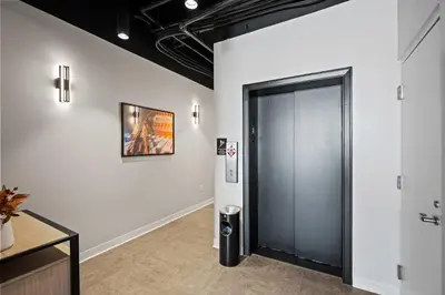 a hallway with a door and a picture on a wall at The 333 Suites 301 - Suite for 6 in Cincinnati