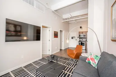 a living room with a couch and a table at The 333 Suites 302 - Stay for 6 in Cincinnati