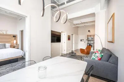 a living room with a couch and a bed at The 333 Suites 302 - Stay for 6 in Cincinnati